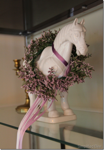 misty floral wreath around horse figurine