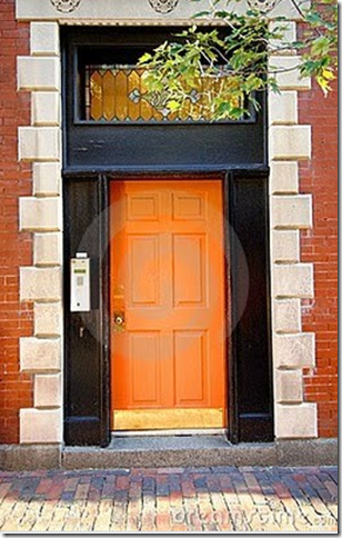 orange black front door brick home