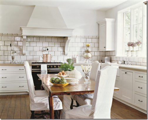 white kitchen with farm table designer