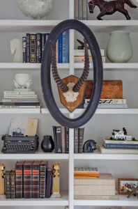 stylish bookcase with atlers and neutral accents
