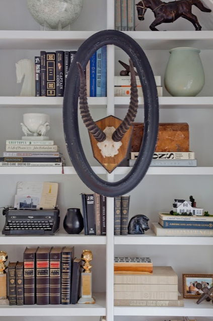 stylish bookcase with atlers and neutral accents