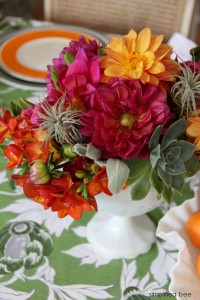 pink and orange floral arrangement with succulents