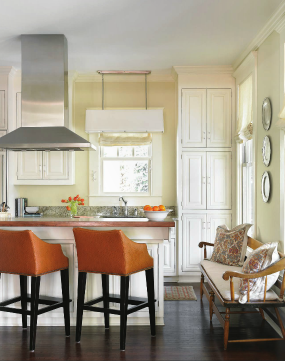 gourmet kitchen with orange barstools