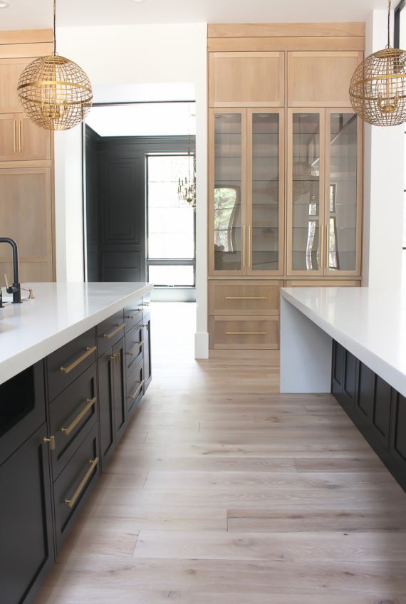 kitchen / white oak cabinets and double waterfall islands